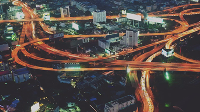 Birds eye view of metropolitan city and its highway system at night